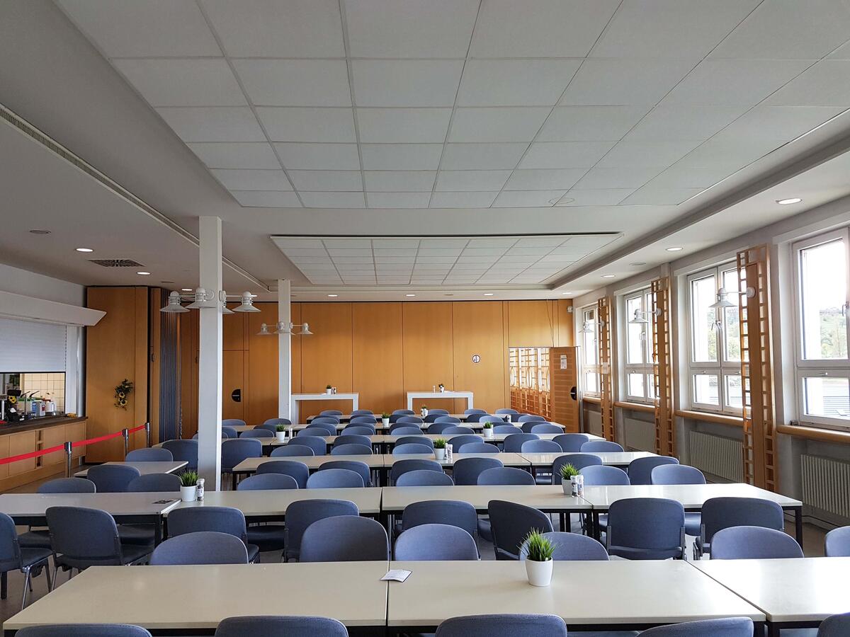 Interior view of the Göppingen canteen with tables and blue chairs